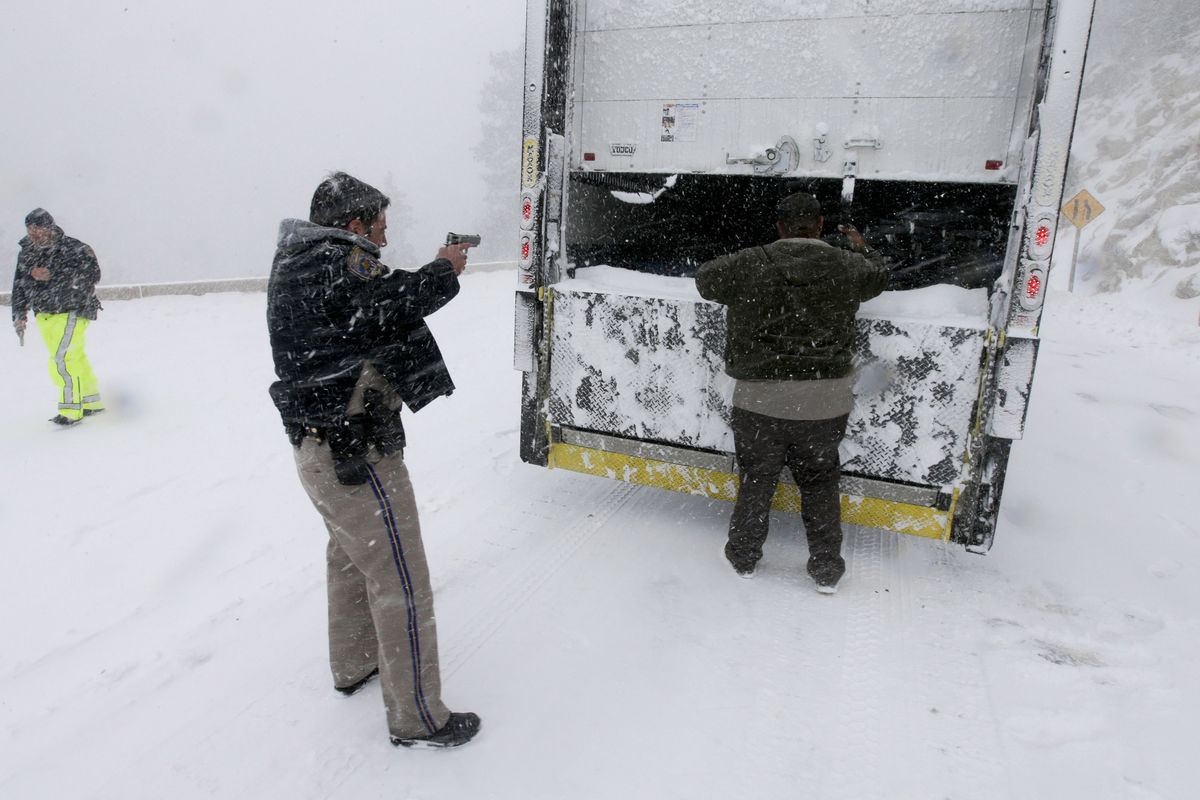 Members of the California Highway Patrol search a truck Friday for Christopher Dorner, a former Los Angeles police officer accused of carrying out a killing spree because he felt he was unfairly fired from his job. (Associated Press)