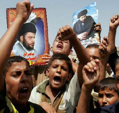 
Young followers of Muqtada al-Sadr rally in support for their leader, seen in the posters, in the Sadr City Shiite district, in Baghdad on Thursday.  
 (Associated Press / The Spokesman-Review)