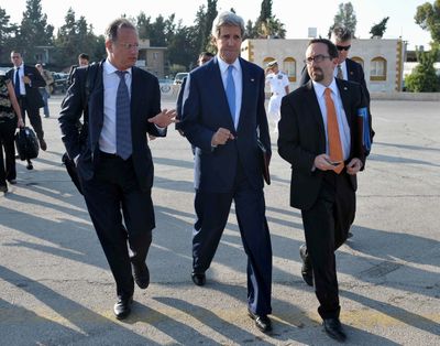Secretary of State John Kerry, center, makes his way to board a flight to reach the West Bank city of Ramallah, where he was expected to hold new talks with Palestinian president Mahmuod Abbas in the Jordanian capital Amman on July 2013. (Associated Press)