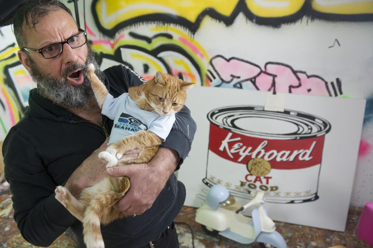 Artist and musician Charlie Schmidt holds Bento, aka “Keyboard Cat,” the feature actor in his many YouTube videos Jan. 29, 2014 in his studio in Spokane. (Jesse Tinsley / The Spokesman-Review)