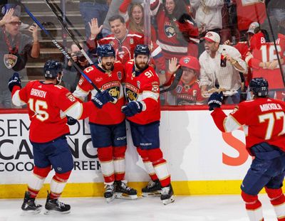 Florida Panthers’ Sam Reinhart celebrates his goal with teammates Aleksander Barkov, left, and Oliver Ekman-Larsson, right, on Monday in Sunrise, Fla.  (Taylor Newquist / The Spokesman-Review)