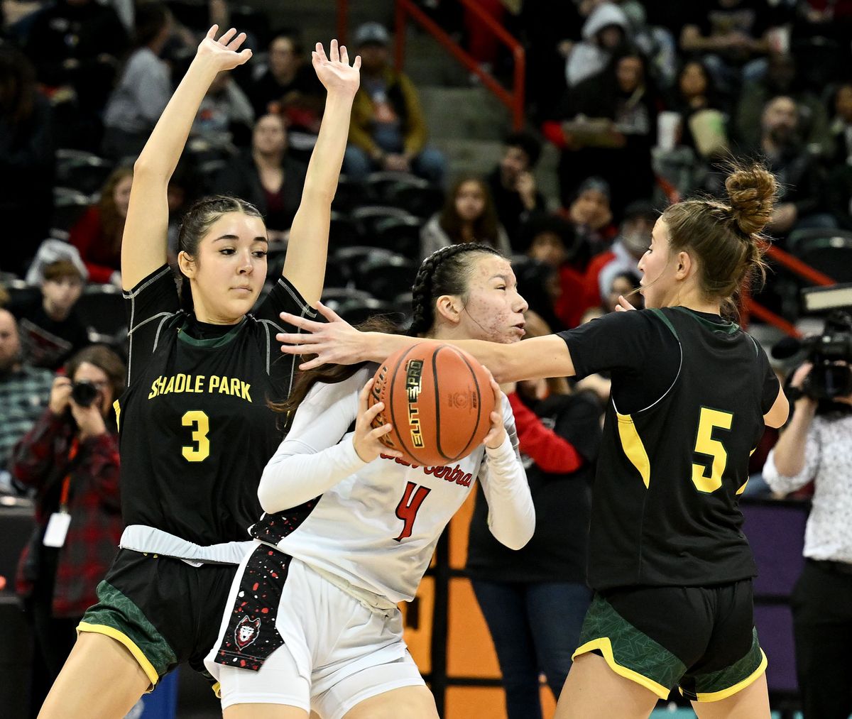 North Central’s Feather Auld heads to the basket as Shadle Park’s Julia Licea, left, and Addison Jahn defend during the second half of Tuesday’s Groovy Shoes spirit game at the Arena.  (Colin Mulvany/The Spokesman-Revi)