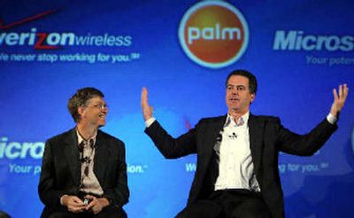 
Palm Inc. president and chief executive Ed Colligan, right, gestures in front of Microsoft Corp. chairman and chief software architect Bill Gates, left, as they announce the new Palm Treo smart phone during a joint news conference with Verizon Wireless. 
 (Associated Press / The Spokesman-Review)