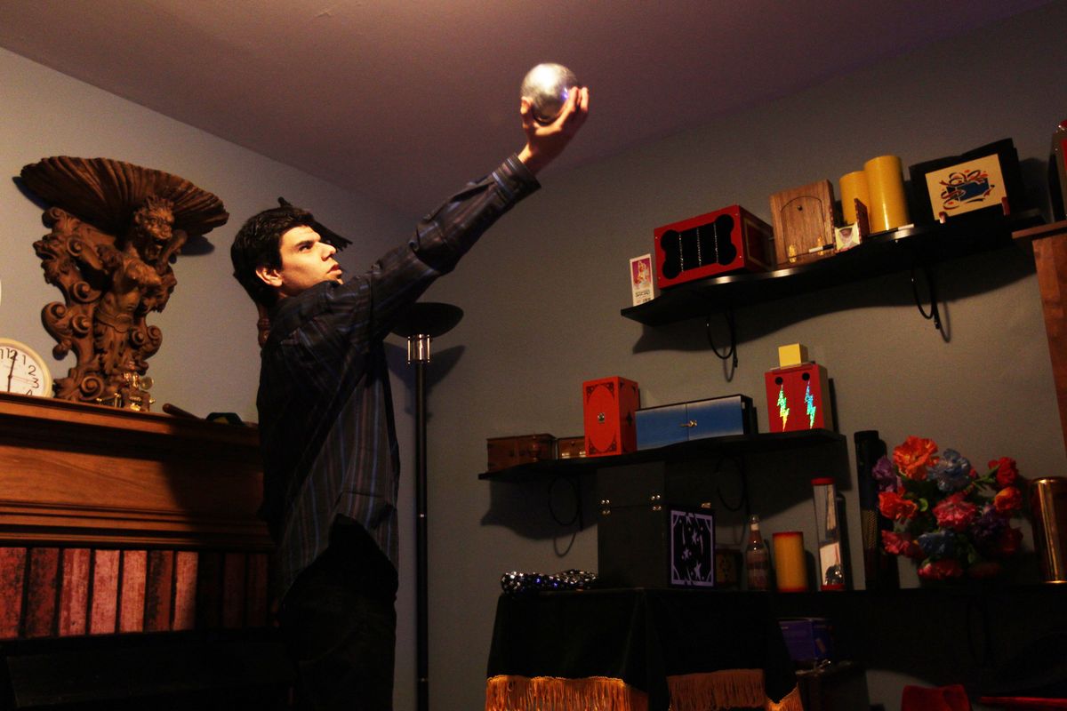 Trent Rivas practices The Zombie Ball, a magic trick, in the basement of his home.