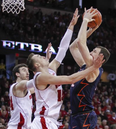 Maverick Morgan of Illinois shoots against Sam Dekker, center, and Frank Kaminsky of Wisconsin in the Badgers’ 68-49 win. (Associated Press)
