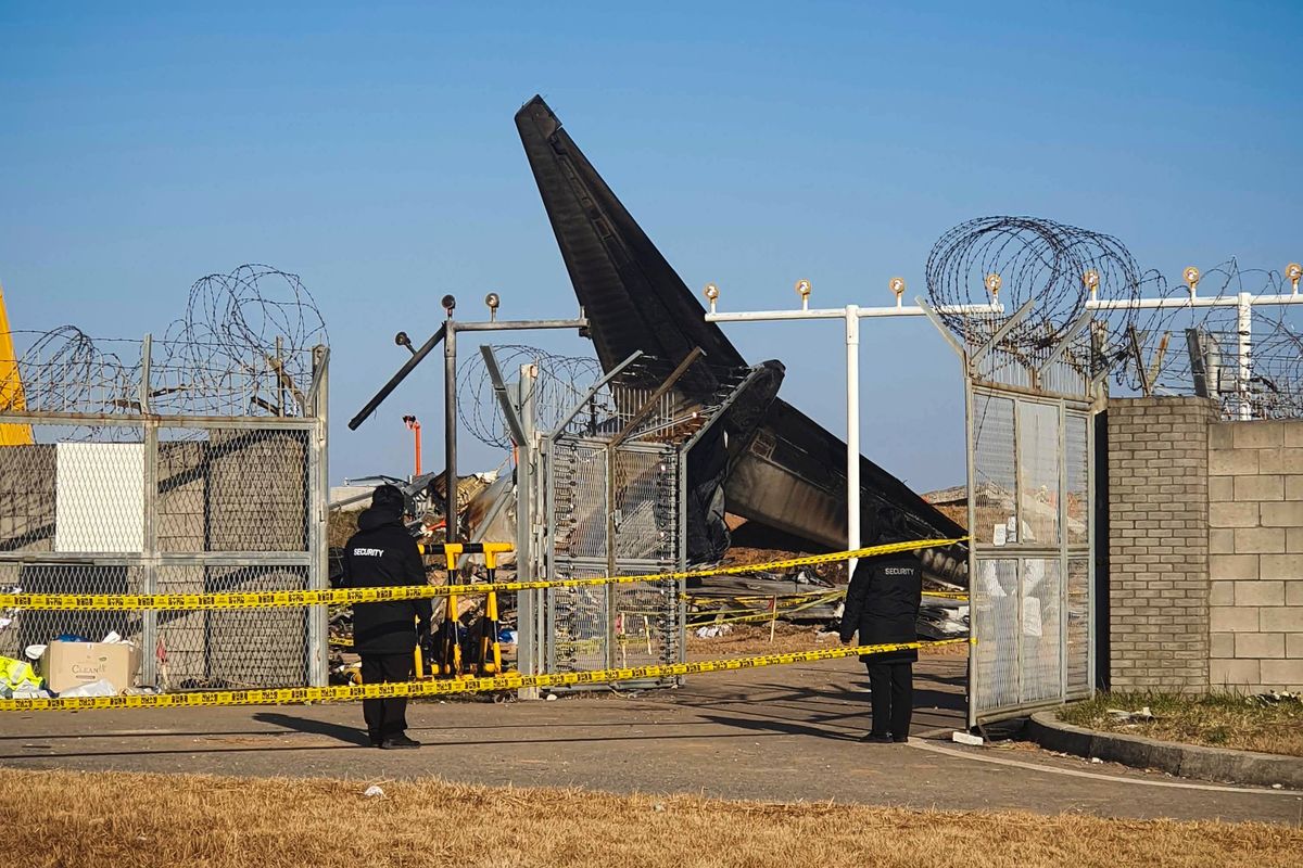 Investigators examine the wreckage of the Jeju Air plane crash on Wednesday at Muan International Airport in South Korea.  (Andrew Jeong/TWP)