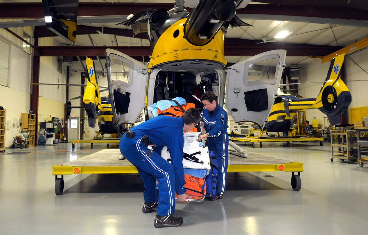 Respiratory therapist Dan Ogilvie  and registered nurse Tracy Goldrick load the back of a MedStar helicopter at Felts Field on Monday.  (Christopher Anderson / The Spokesman-Review)