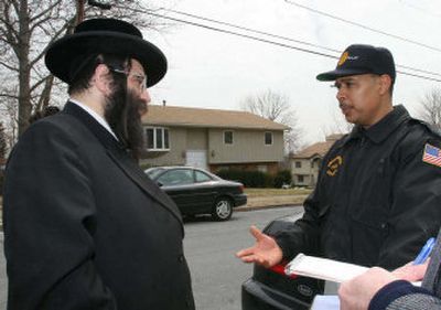 
Rabbi Aaron Winternitz talks Monday with building inspector Manny Carmona. 
 (Associated Press / The Spokesman-Review)