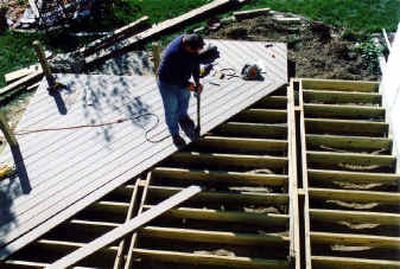 
The deck surface is applied on 12-inch centers. This accommodates the sag of composite decking. The workman uses an upright drill to drive down the stainless steel screws. The deck surface is applied on 12-inch centers. This accommodates the sag of composite decking. The workman uses an upright drill to drive down the stainless steel screws. 
 (Associated Press photosAssociated Press photos / The Spokesman-Review)
