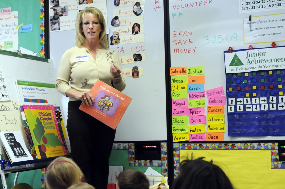 Julie Ryen,  of Sterling Savings Bank, gives a short presentation to a group of kindergartners March 25  at Holmes Elementary School. Ryen volunteers for Junior Acheivement, a program that promotes  business success, financial education and entrepreneurship.  (Photos by JESSE TINSLEY / The Spokesman-Review)