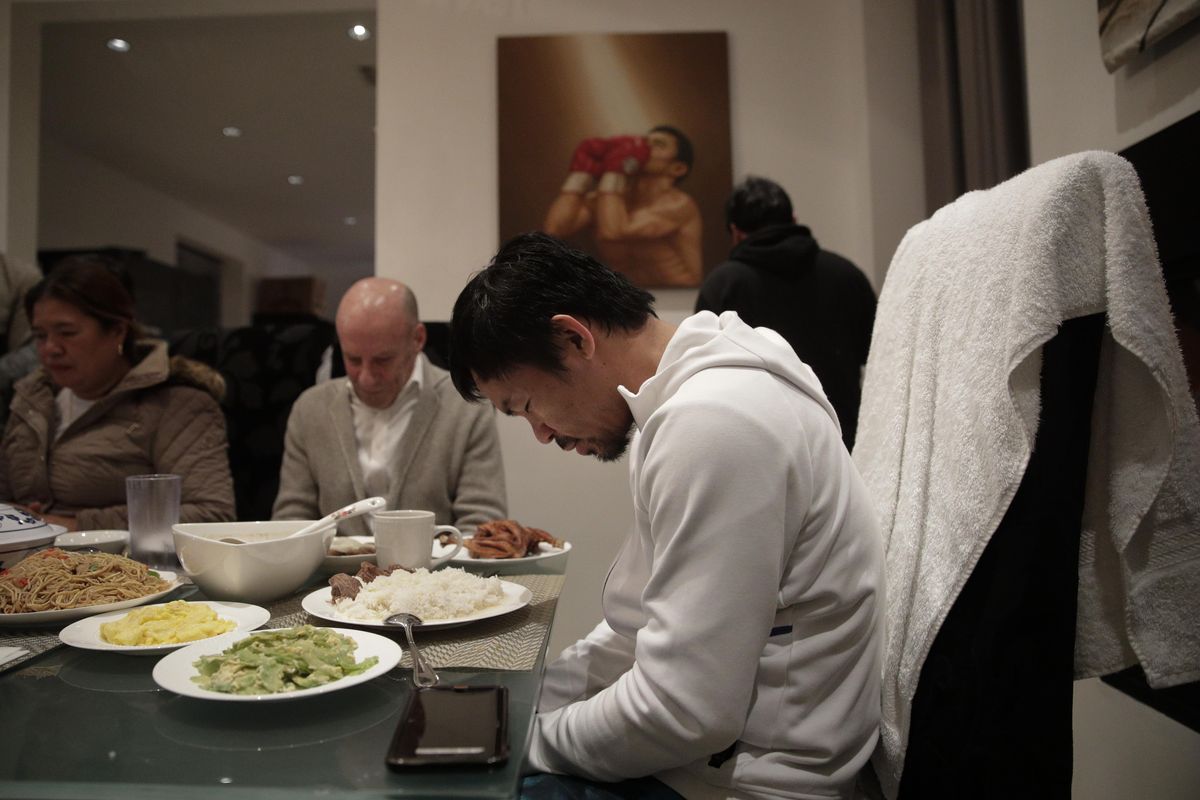 Boxer Manny Pacquiao prays before breakfast at his home following his morning run Monday, Jan. 14, 2019, in Los Angeles. Breakfast at Manny Pacquiao’s house began with a silent prayer, followed by more silence around the big dining room table as his entourage waited for the fighter to take the first bite. (Jae C. Hong / Associated Press)