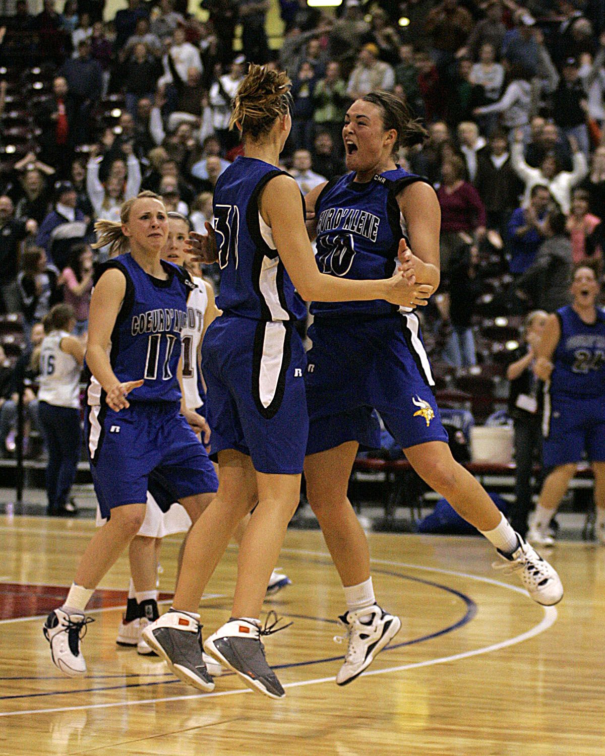 CdA’s Kama Griffitts exults in a huge basket by Whitney Heleker, center, as Sadie Simon looks on. (Steve Conner Photography / The Spokesman-Review)