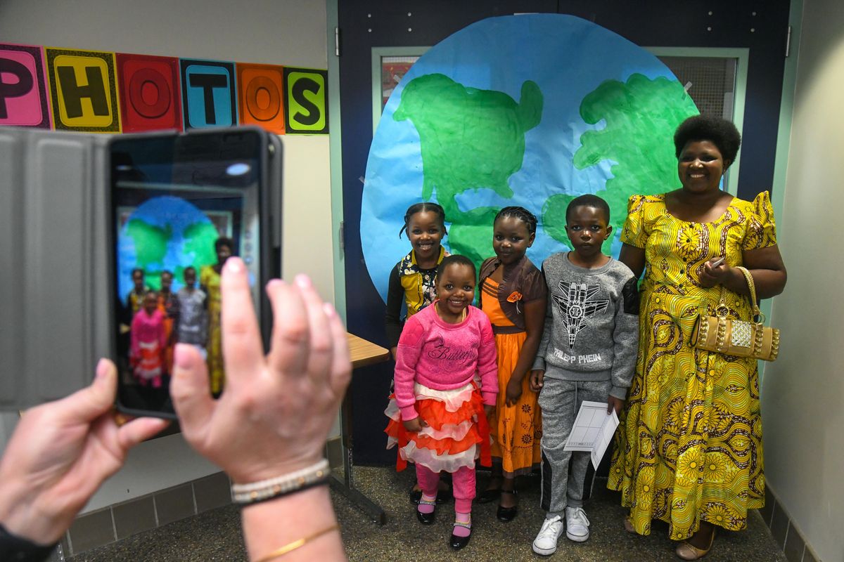 Merinas Nifasha, from the African nation of Burundi, right, and her children, from left, Upendo, first grader, Rihema, pre-school, Furaha, second grade, Amani, third grade, pause in the school hallway for a group shot during the Stevens Elementary School Culture Day, May 10, 2018, in Spokane, Wash. (Dan Pelle / The Spokesman-Review)