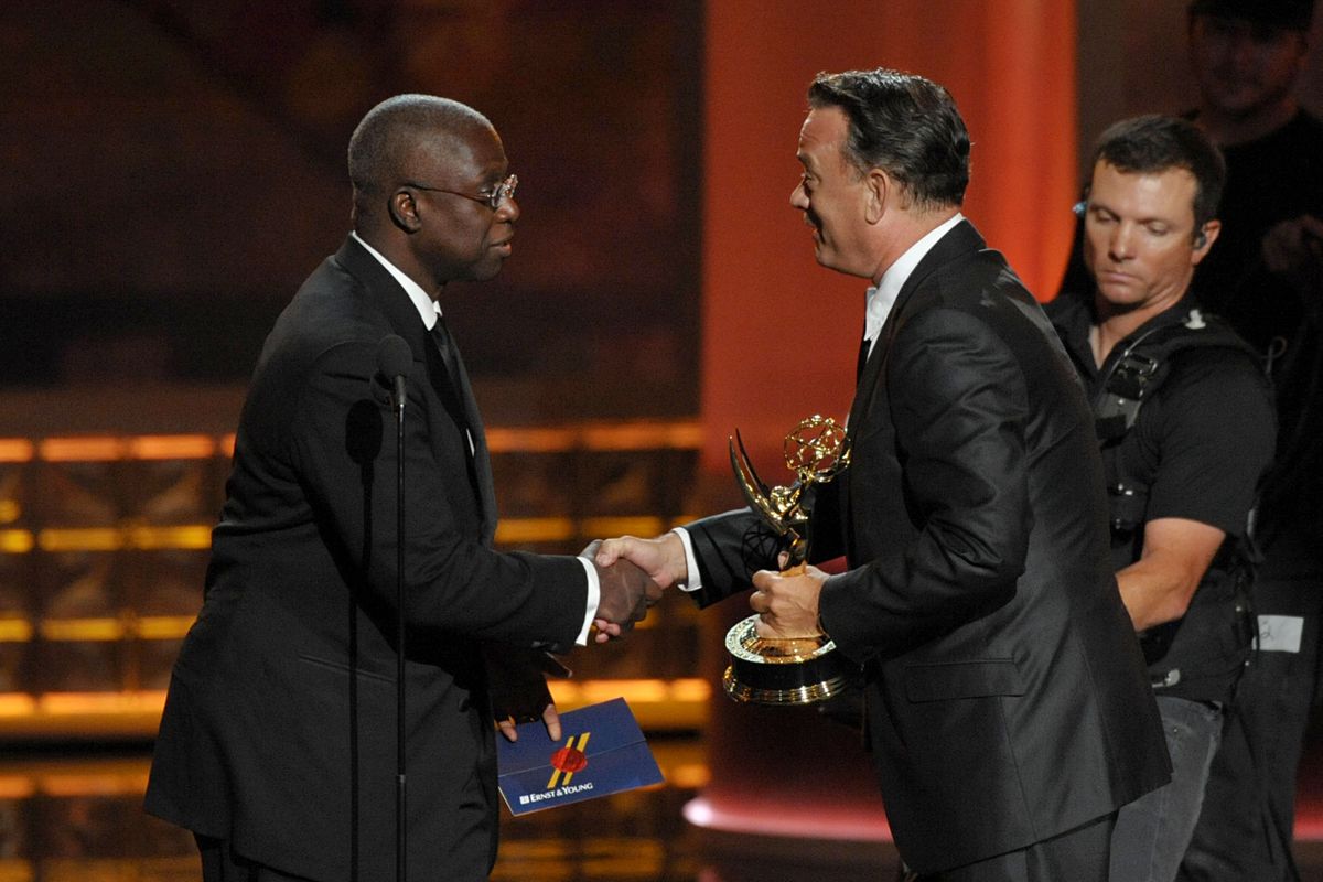 Andre Braugher, left, presents the award for Outstanding Miniseries Or Movie to Tom Hanks for "Game Change" at the 64th Primetime Emmy Awards at the Nokia Theatre on Sunday, Sept. 23, 2012, in Los Angeles. (Photo by John Shearer/Invision/AP) (John Shearer / Invision)