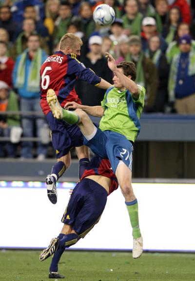 Real Salt Lake’s Nat Borchers, left, and Chris Wingert, bottom, challenge the Seattle Sounders’ Nate Jaqua in the first half of their MLS soccer match Saturday at Qwest Field in Seattle.  (Associated Press / The Spokesman-Review)