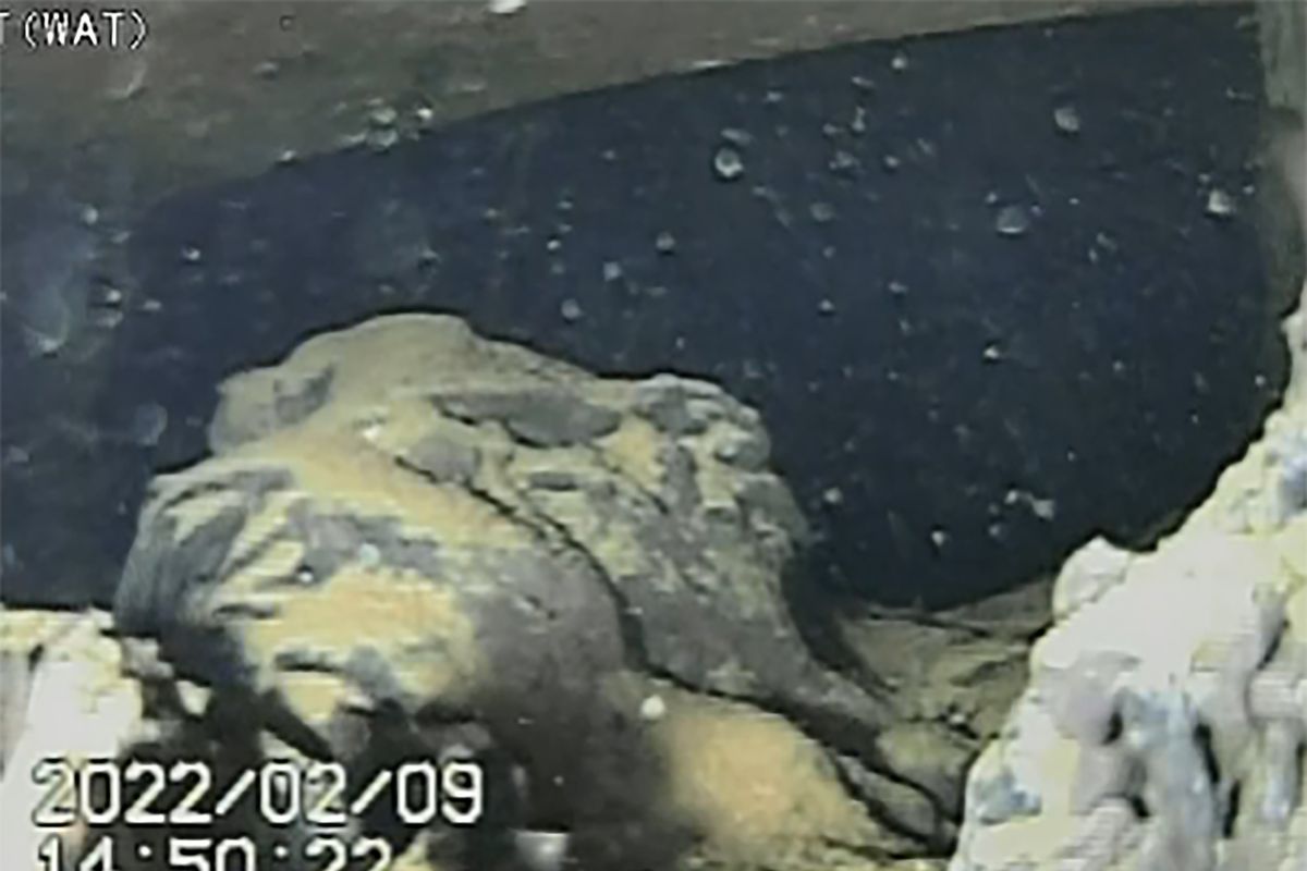 Images from a remote-controlled submersible robot show damaged areas inside the Fukushima nuclear power plant damaged in the 2011 earthquake and tsunami, Wednesday, Feb. 9, 2022, in Fukushima, Japan. The robot captured images of what appears be mounds of damaged fuel that had melted and fell to the bottom of the hardest-hit reactor at the nuclear plant for the first time since the 2011 disaster. (HOGP)