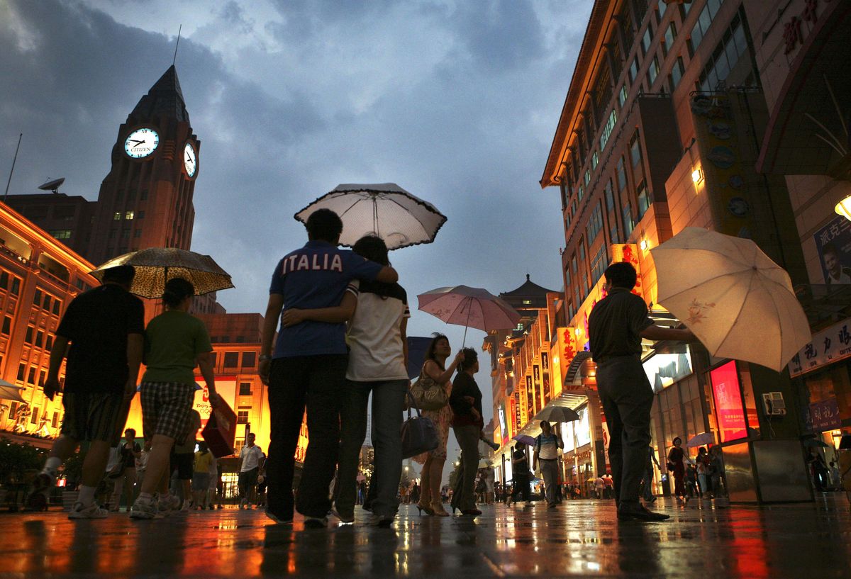 Shoppers walk on Wangfujing Street, one of the primary shopping centers in Beijing, China.  (Associated Press / The Spokesman-Review)
