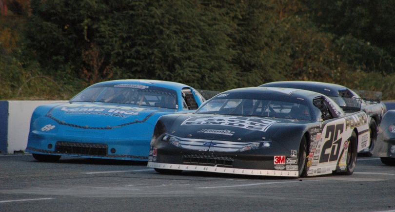 Bubba Pollard (26) and Garrett Evans (64) race side-by-side for the lead at the Evergreen Speedway Summer Showdown.  They finished first and second respectively. (Photo Credit M.E. Wright)