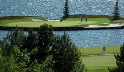 
 Golfers putt on the  floating green at the Coeur d'Alene Resort Golf Course Saturday. Fees collected from golfers at the course are funding waterways improvements around the region. 
 (Jesse Tinsley / The Spokesman-Review)