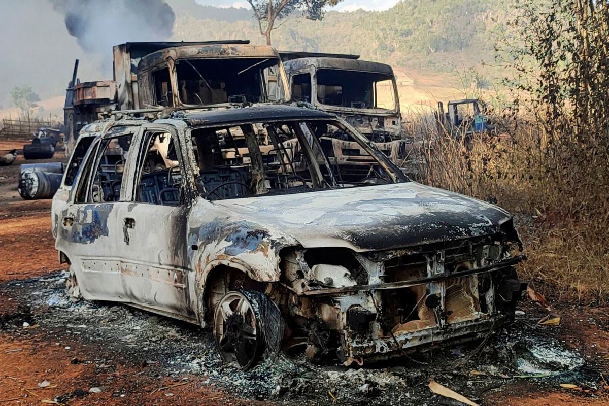 In this photo provided by the Karenni Nationalities Defense Force (KNDF), vehicles smolder in Hpruso township, Kayah state, Myanmar, Friday, Dec. 24, 2021. Myanmar government troops rounded up villagers, some believed to be women and children, fatally shot more than 30 and set the bodies on fire, a witness and other reports said Saturday.  (HONS)