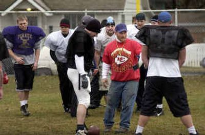 
Kootenai County Eagles semipro football team head coach Tim Winters, center, in red sweatshirt, talks with his players during practice  at Persons Field. 
 (Tom Davenport/ / The Spokesman-Review)