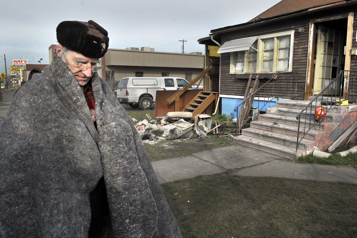 Richard Henderson wraps himself in a blanket after a fire forced him out of a house on East Sprague Avenue where he was renting Tuesday, March 16, 2010. The house was posted as uninhabitable by the Spokane Fire Department. (Christopher Anderson / The Spokesman-Review)