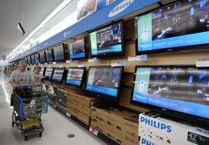 Shoppers walk past televisions on display in the electronics department of a Wal-Mart store in Rogers, Ark. Wal-Mart Stores Inc. is upgrading its beef, clothing, electronics and home accessories while sprucing up its stores.Associated Press photos (Associated Press photos / The Spokesman-Review)