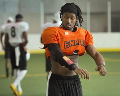 Spokane Empire starting quarterback Charles Dowdell tries on his new jersey and pads on the first day of practice at the Spokane Soccer Center. Dowdell and the Empire start the season Saturday at the Tri-Cities. Kickoff is set for 7 p.m. (Dan Pelle / The Spokesman-Review)