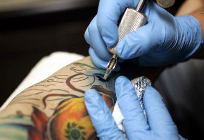 
John Brady, 22, of College Park, Md., gets a tattoo at a parlor in Washington, D.C. According to a survey, about 36 percent of Americans age 18 to 29 have at least one tattoo.
 (Associated Press / The Spokesman-Review)