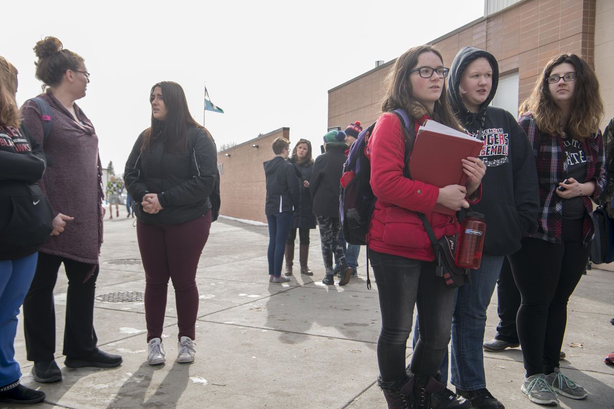 Cheney High School students stand outside the school entrance and take turns giving their thoughts on recent school shootings Wednesday, Feb. 21, 2018, during a lunch-hour walkout and protest. (Jesse Tinsley / The Spokesman-Review)