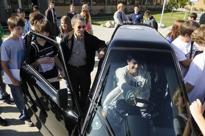 In this file photo, Rick Woodbury, center left, lets Gonzaga Prep student Cameron Dolsby, 14, sit behind the wheel of Woodbury’s electric car called the Tango during a visit to the school on Sept. 26, 2008. (Dan Pelle / The Spokesman-Review)
