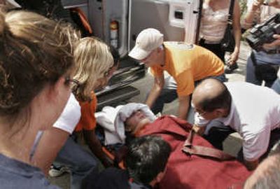 
Francesca Lewis is carried on a stretcher into an ambulance Wednesday in the town of David, Panama, after being rescued from the site of a small plane crash. Associated Press
 (Associated Press / The Spokesman-Review)