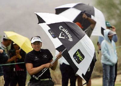 
 Annika Sorenstam shields herself from rain during the Samsung World Championship. 
 (Associated Press / The Spokesman-Review)