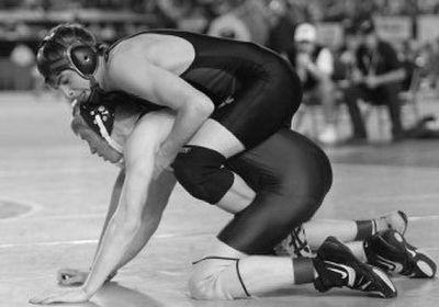 
Republic's J.J. Gubler, top, rides Robert Langloss of Kittitas on the way to a 7-5 win in the 119-pound championship during Saturday's Mat Classic in Tacoma. 
 (Patrick Hagerty Special to / The Spokesman-Review)