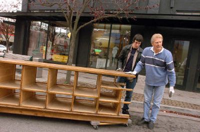 
Owner Jim Cate, right, and son Jack look for a way to load and move some of the antique store furnishings from The Penny Candy Store on Friday in downtown Coeur d'Alene. The store is closing because rent is being raised following a renovation of the historic building. 
 (Jesse Tinsley photos/ / The Spokesman-Review)