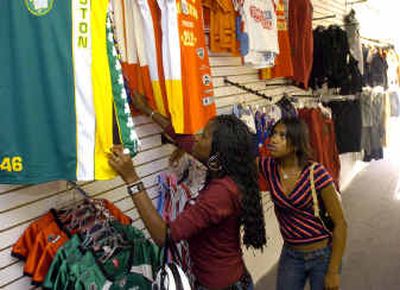 
At the Urban Fashions store in Hillyard, Tameisha Palmer, 17, left, and her friend Brittany Baynes, 18, check out the jersey dresses Tuesday. 
 (Colin Mulvany / The Spokesman-Review)