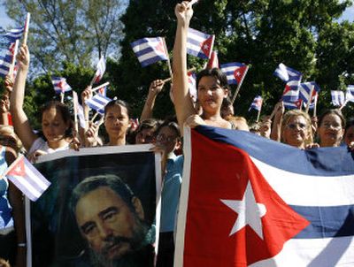 
Supporters of ailing Cuban leader Fidel Castro wave flags Sunday in Havana. 
 (Associated Press / The Spokesman-Review)