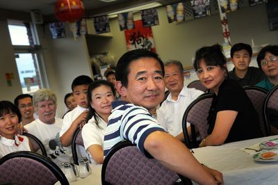 Members of the Spokane Chinese Association discuss  the Olympics. In foreground is Lijun Bai, and to his right is his wife, Jane Gong, president of the association.  (Rajah Bose / The Spokesman-Review)