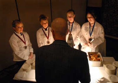 
Culinary arts team members, from left, Mallory Shipps and Amanda Wanrow of Rogers High School and Bethany Duffy and Tiffany Jenkins of Lewis and Clark High School serve appetizers at the gala.
 (The Spokesman-Review)