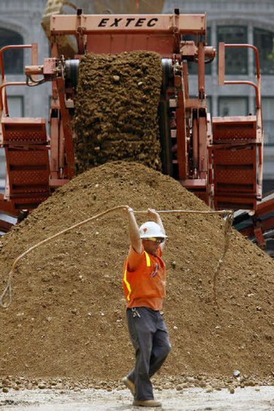 
A construction worker carries a steel cable in front of a construction site on Friday, in downtown Los Angeles. Cautious employers added just 75,000 new jobs in May. 
 (Associated Press / The Spokesman-Review)