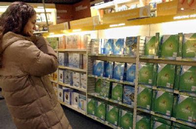 
A woman looks at a Microsoft product at a shop in Brussels. 
 (Associated Press / The Spokesman-Review)