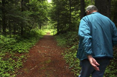 
Osburn resident Bob Dunsmore walks down the original Mullan Road near Fourth of July Pass. He is a local history buff and collects Mullan Road artifacts. 
 (Kathy Plonka / The Spokesman-Review)