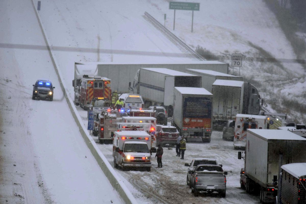 Emergency personnel remove patients for transport to area hospitals at the scene of a multi-vehicle wreck on Interstate 65 near Bonnieville, Ky., Tuesday, Jan. 16, 2018. The wreck shut down the southbound lanes for several hours. Several people were transported from the scene to at least two different hospitals. (Neal Cardin / AP)