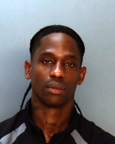 In this handout image provided by the Miami-Dade County Corrections and Rehabilitation, rapper Travis Scott poses for a booking photo on Thursday in Miami.  (Handout)