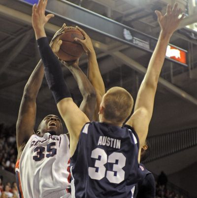 Sam Dower of Gonzaga, left, tries to get shot off as Nate Austin of BYU defends during first-half action of their game on Thursday night. (Christopher Anderson)