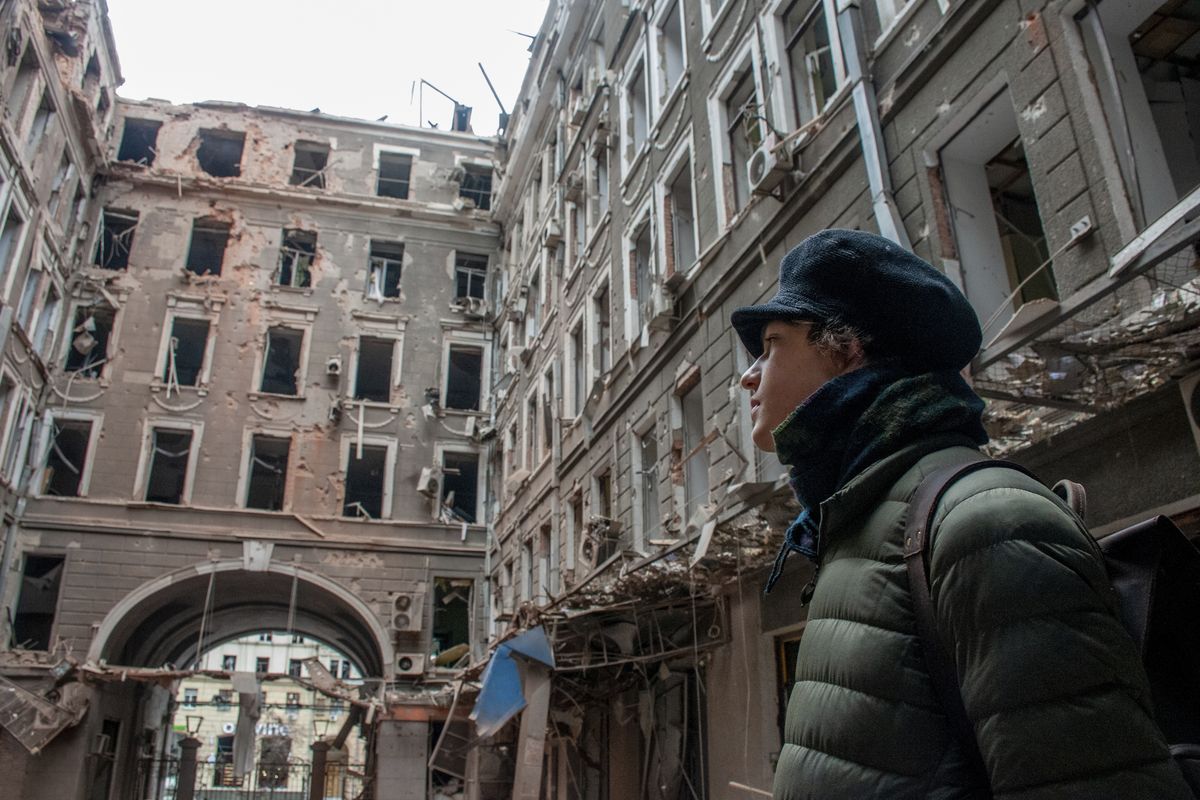 A local resident looks at his house destroyed in a Russian air raid in Kharkiv, Ukraine, Thursday, March 3, 2022. Russia