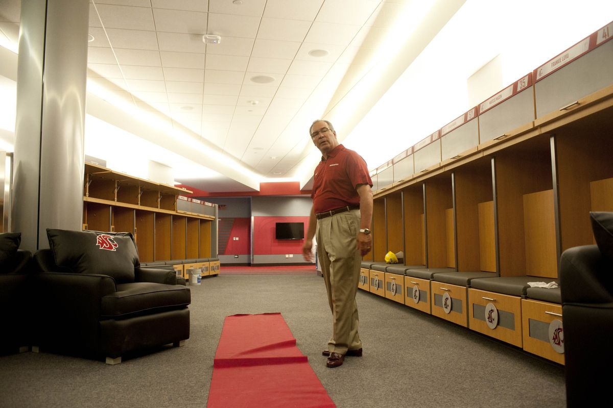 WSU Athletic Director Bill Moos unveils one of the crowning jewels of WSU’s new football operations building -- the locker room -- during a media tour on Tuesday. (Tyler Tjomsland)
