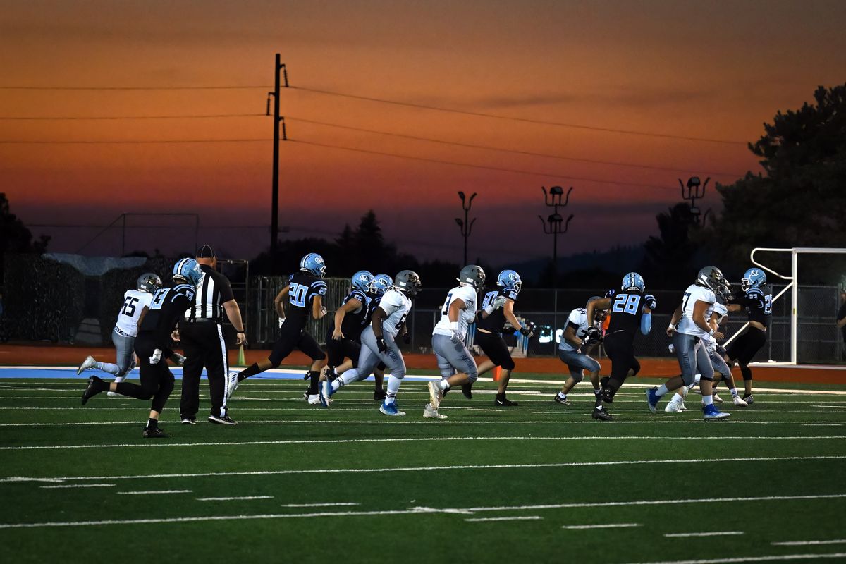 Just after the sun set, Mead and Central Valley run the first play of the evening during a GSL high school football game, Friday, September 30, 2022, at Central Valley High School.  (Colin Mulvany/The Spokesman-Review)