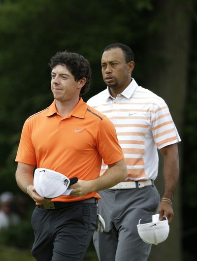 Rory McIlroy, left, is having a season like Tiger Woods, right, had in 2000. (Associated Press)