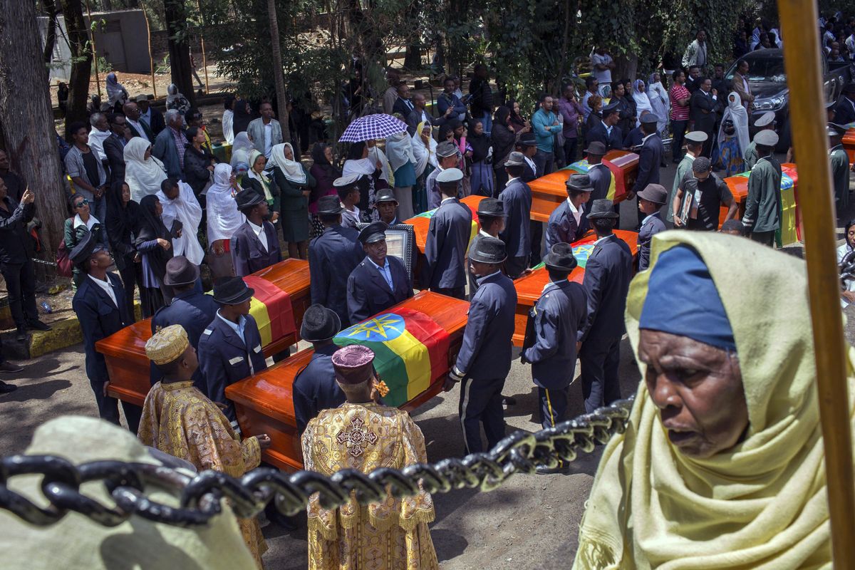Relatives grieve next to empty caskets draped with the national flag at a mass funeral at the Holy Trinity Cathedral in Addis Ababa, Ethiopia Sunday, March 17, 2019. The French civil aviation investigation bureau BEA has concluded there were “clear similarities” between this month’s crash of an Ethiopian Airlines Boeing 737 MAX plane and a Lion Air plane crash last October. (Mulugeta Ayene / AP)